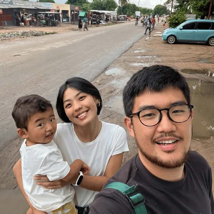 Daisuke e Victoria com o filho no colo, em uma rua